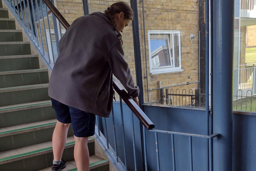 A Woman Cleaning A Staircase