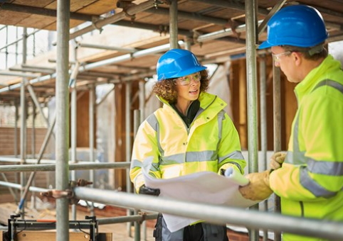 People in hardhats surrounded by scaffolding