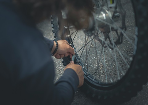 Someone repairing a bike tyre