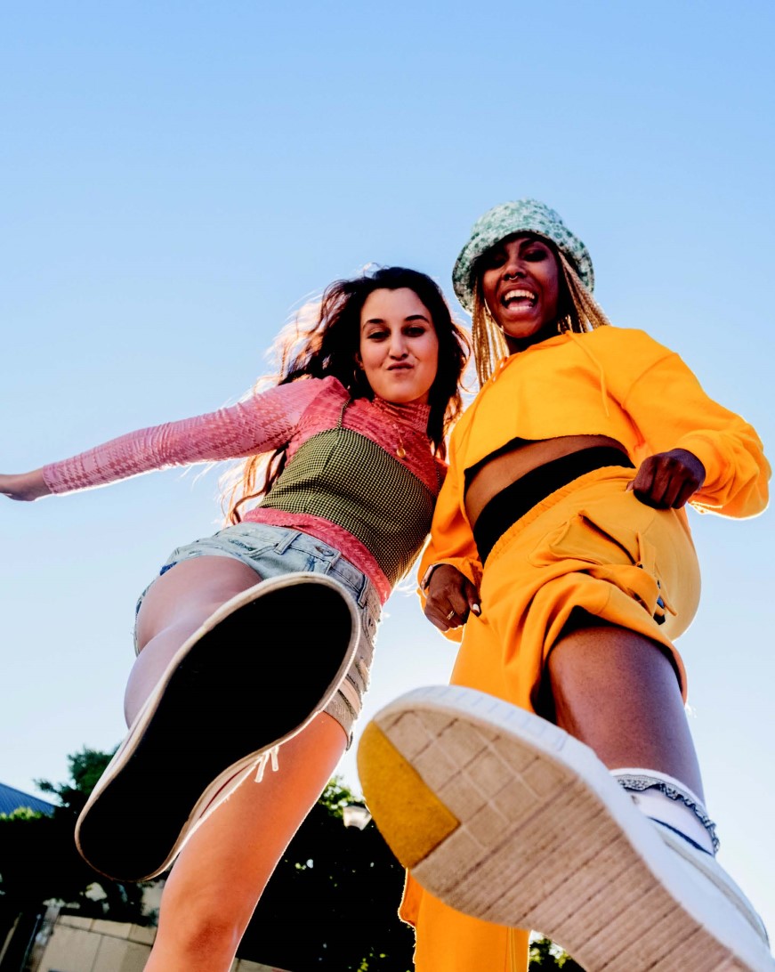 Two young people standing above the camera