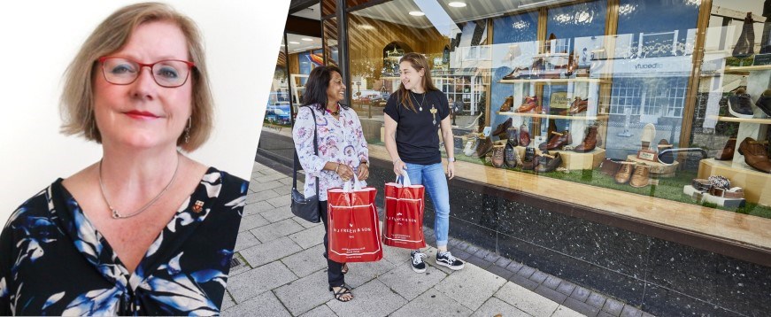 Photo of Leader next to people shopping