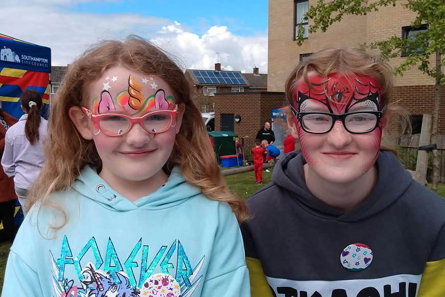 Two children outside wearing facepaint