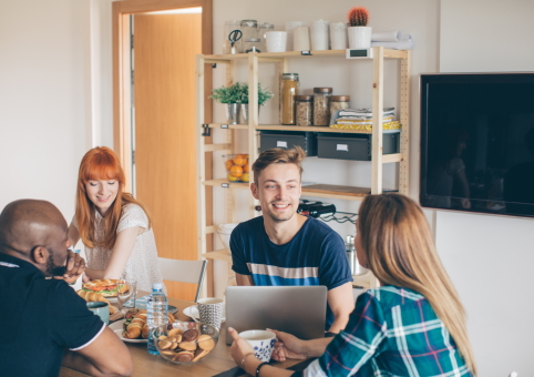 Adults sitting around a kitchen table