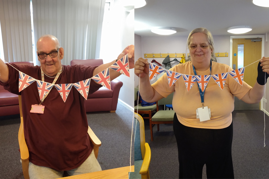 People Holding Up British Flag Bunting