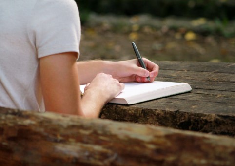 A person writing in a book