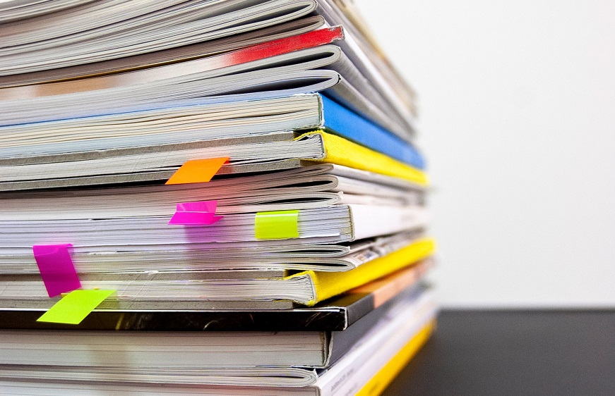 A pile of books with reference cards in them