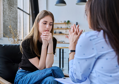 Young person speaking to a professional
