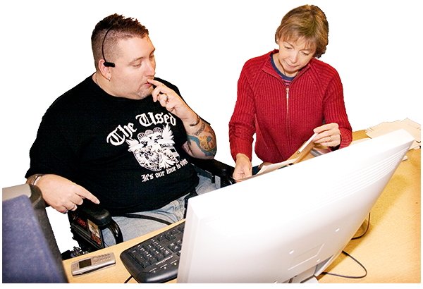 Disabled man receiving advice at work desk