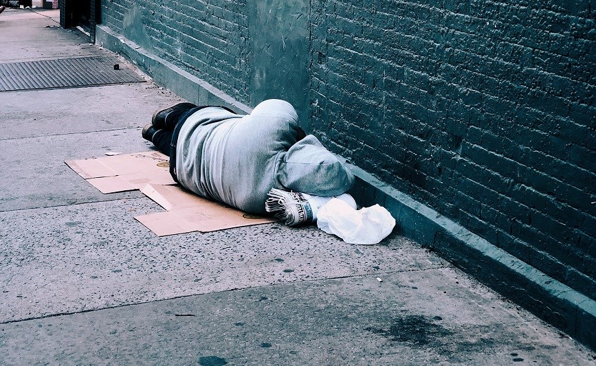 A homeless person sleeping on the street