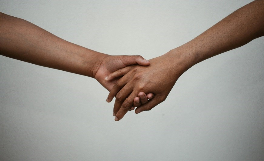 Two hands holding each other