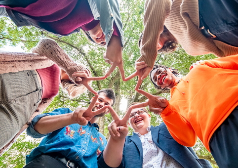 People making a shape with their hands