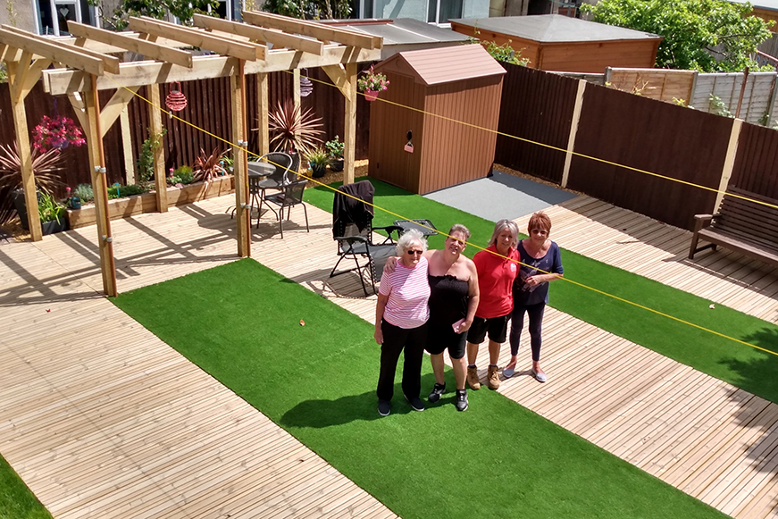 Four friends enjoying the updated garden