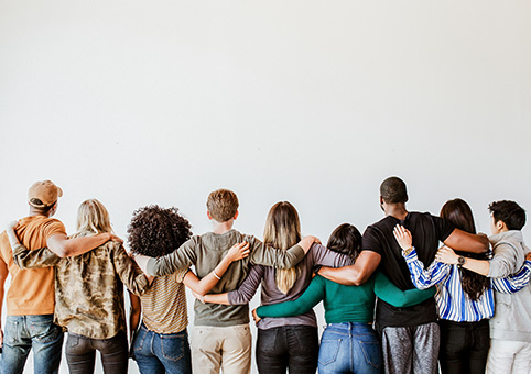 People in a line with their arms around each other