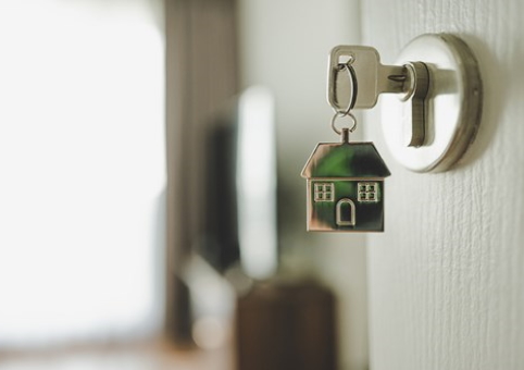 Key in a door with a house keychain